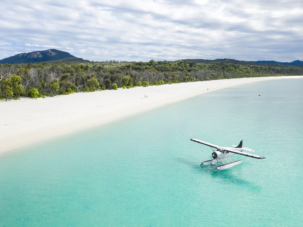Watervliegtuig land op het water bij een van de stranden van Witsundays