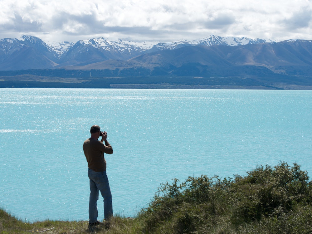 Fotograaf maakt een foto aan de rand van Lake Tekapo in Nieuw-Zeeland