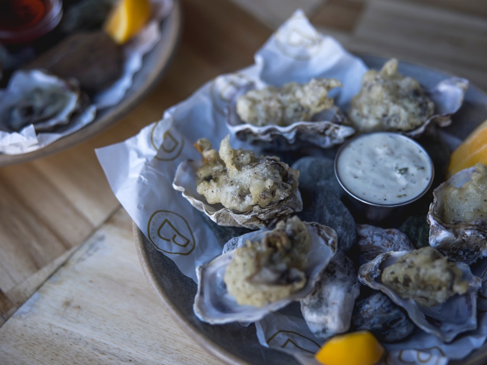 A plate of fresh oysters and dip