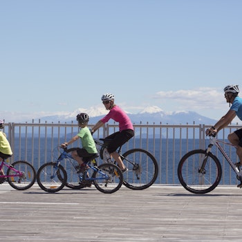 Een familie fietst over de Tongariro River Trail